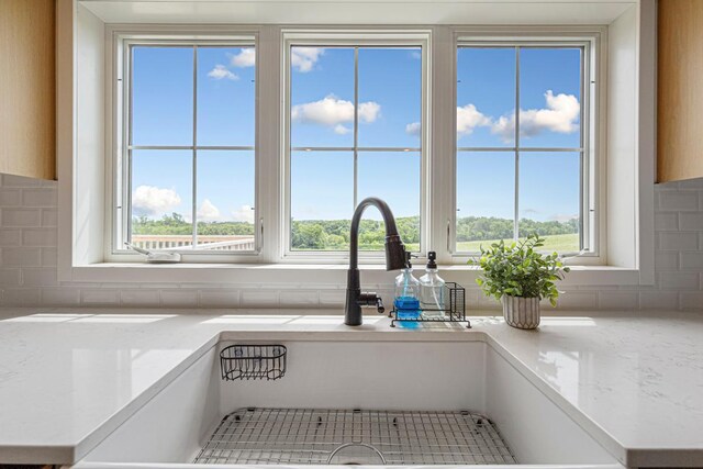 13827 Halstad Ave, Lonsdale, MN 55046 - bathroom featuring backsplash and healthy amount of natural light
