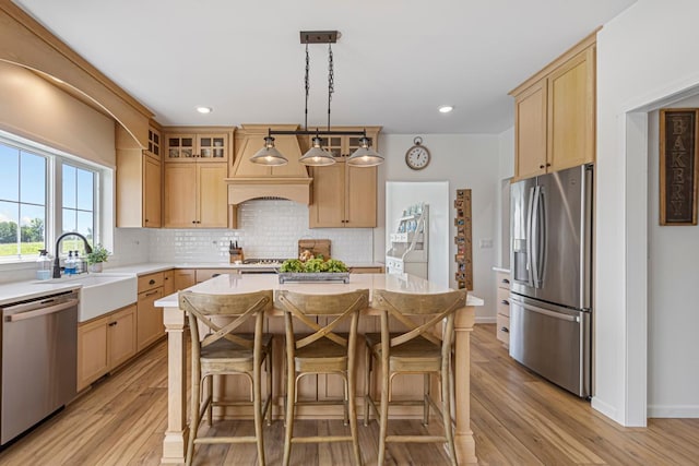 13827 Halstad Ave, Lonsdale, MN 55046 - kitchen featuring stainless steel appliances, light countertops, light brown cabinets, tasteful backsplash, and recessed lighting