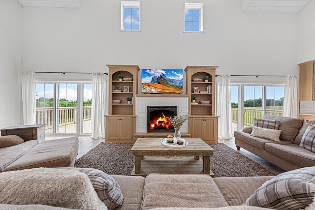 13827 Halstad Ave, Lonsdale, MN 55046 - living room with a towering ceiling, plenty of natural light, and a warm lit fireplace