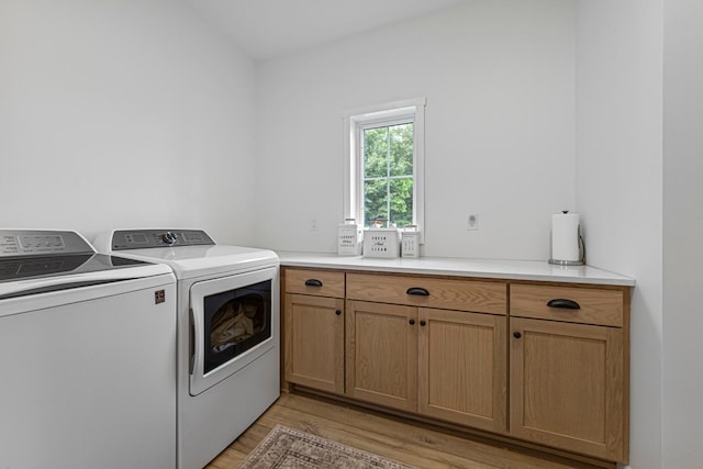 13827 Halstad Ave, Lonsdale, MN 55046 - laundry room featuring washer and clothes dryer, light wood finished floors, and cabinet space