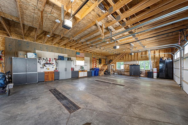13827 Halstad Ave, Lonsdale, MN 55046 - garage featuring a garage door opener and fridge