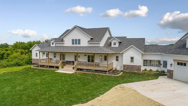 13827 Halstad Ave, Lonsdale, MN 55046 - back of property featuring a porch, roof with shingles, concrete driveway, stone siding, and a yard