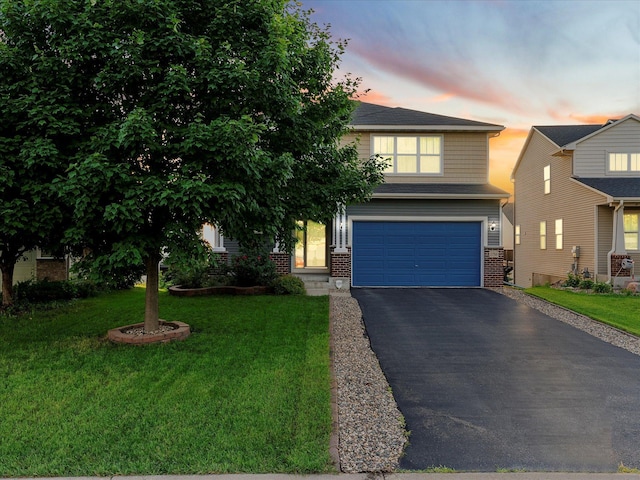 1788 Fescue Ct, Shakopee, MN 55379 - view of front of house featuring a garage, brick siding, asphalt driveway, and a front lawn
