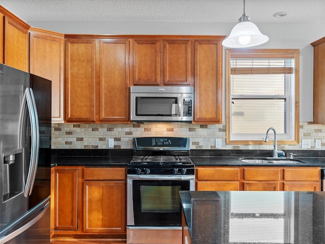 1788 Fescue Ct, Shakopee, MN 55379 - kitchen featuring stainless steel appliances, tasteful backsplash, dark stone countertops, and a textured ceiling