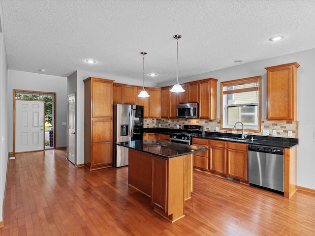 1788 Fescue Ct, Shakopee, MN 55379 - kitchen with stainless steel appliances, light wood-type flooring, backsplash, healthy amount of natural light, and a textured ceiling