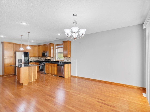 1788 Fescue Ct, Shakopee, MN 55379 - kitchen with appliances with stainless steel finishes, dark countertops, light wood-type flooring, tasteful backsplash, and recessed lighting
