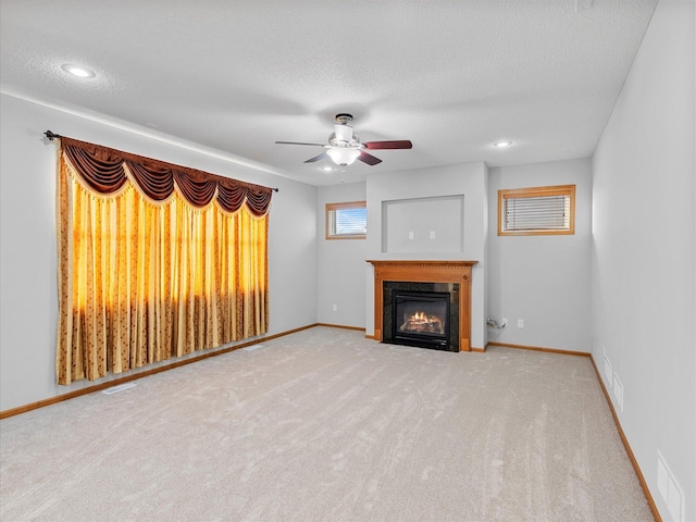 1788 Fescue Ct, Shakopee, MN 55379 - unfurnished living room with a fireplace with flush hearth, ceiling fan, carpet floors, a textured ceiling, and recessed lighting