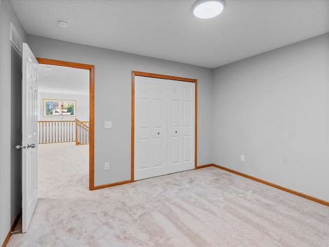 1788 Fescue Ct, Shakopee, MN 55379 - unfurnished bedroom featuring light carpet, a closet, and a chandelier