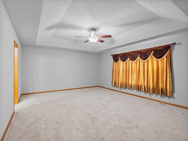 1788 Fescue Ct, Shakopee, MN 55379 - carpeted empty room featuring a ceiling fan, a tray ceiling, and a textured ceiling