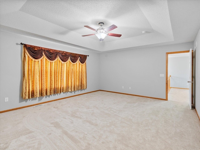 1788 Fescue Ct, Shakopee, MN 55379 - unfurnished room with a raised ceiling, light colored carpet, a ceiling fan, and a textured ceiling