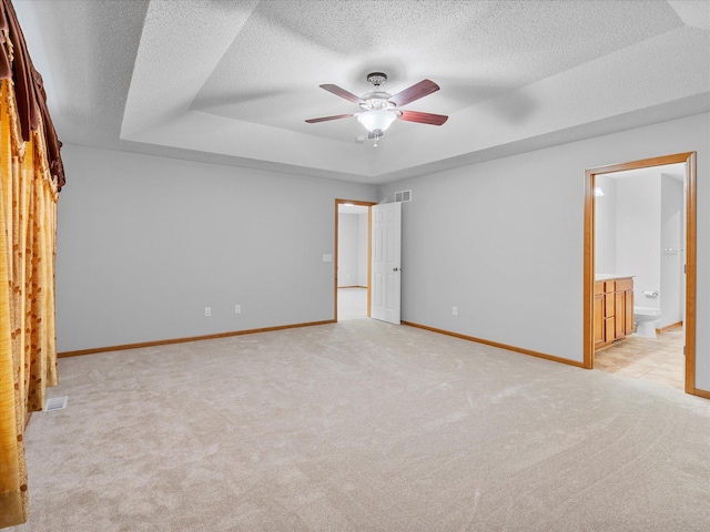 1788 Fescue Ct, Shakopee, MN 55379 - empty room featuring a tray ceiling, light carpet, ceiling fan, and a textured ceiling