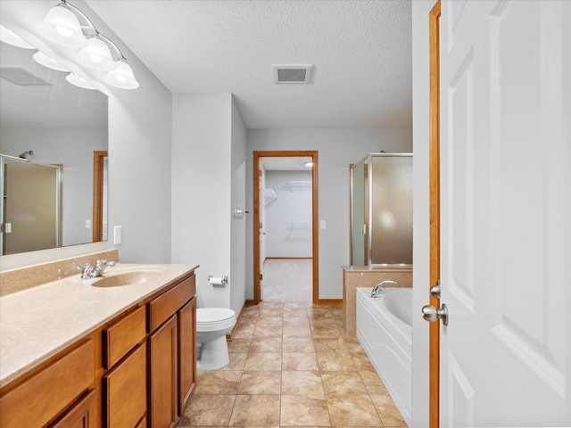 1788 Fescue Ct, Shakopee, MN 55379 - bathroom with a stall shower, a garden tub, a spacious closet, double vanity, and a textured ceiling