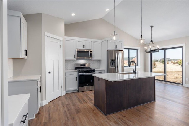 885 183rd Ct, Star Prairie, WI 54017 - kitchen featuring stainless steel appliances, light countertops, tasteful backsplash, vaulted ceiling, and dark wood finished floors