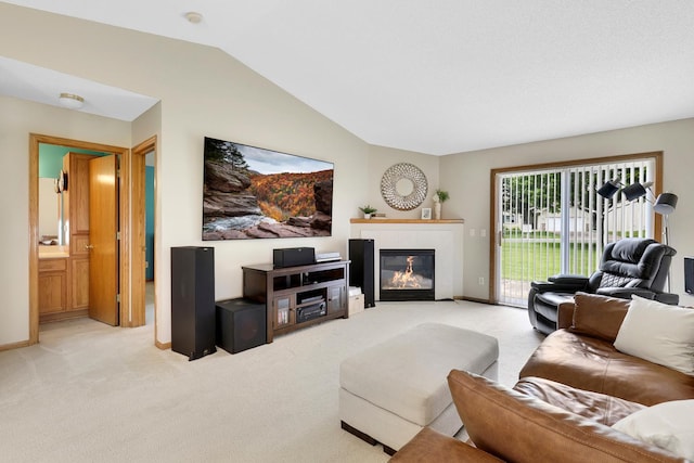 314 Archibald Ln, Dundas, MN 55019 - living area featuring light colored carpet, vaulted ceiling, and a glass covered fireplace