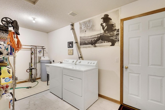 314 Archibald Ln, Dundas, MN 55019 - washroom with washer and dryer, light marble finish floors, and a textured ceiling