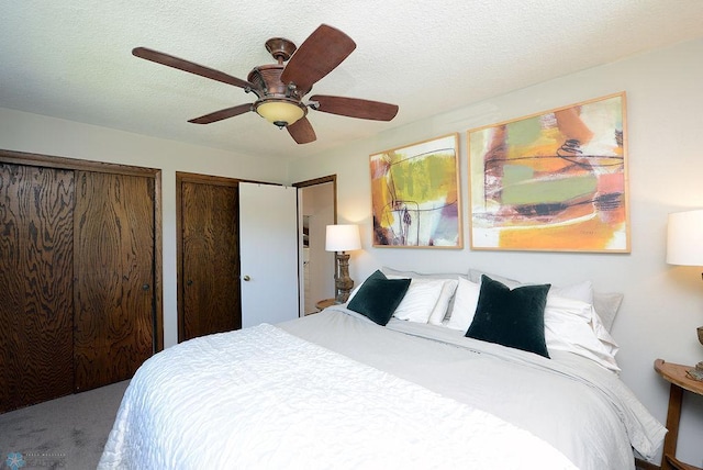 2833 1st St N, Fargo, ND 58102 - bedroom featuring multiple closets, ceiling fan, and a textured ceiling
