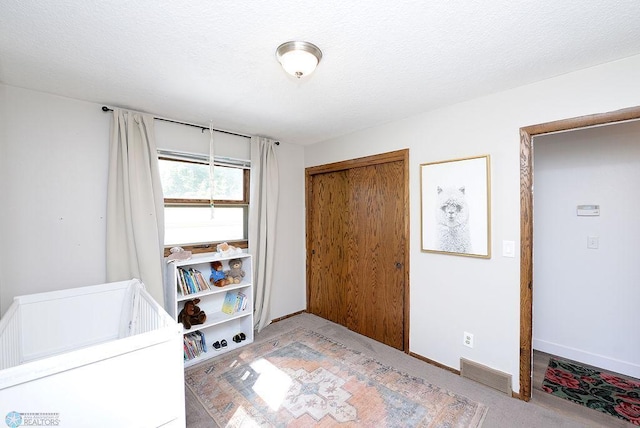 2833 1st St N, Fargo, ND 58102 - bedroom with a closet, carpet flooring, and a textured ceiling