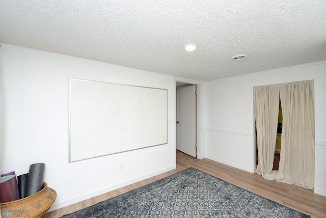 2833 1st St N, Fargo, ND 58102 - home theater with wood finished floors and a textured ceiling