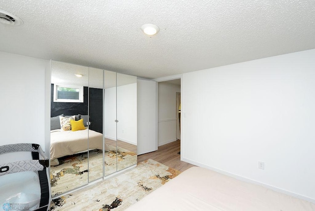 2833 1st St N, Fargo, ND 58102 - bedroom with wood finished floors and a textured ceiling