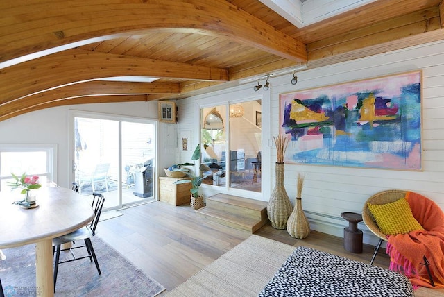 2833 1st St N, Fargo, ND 58102 - dining space with arched walkways, beam ceiling, wood walls, and wood finished floors
