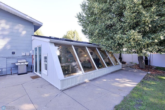 2833 1st St N, Fargo, ND 58102 - view of side of home featuring a sunroom and a patio