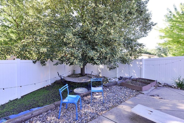 2833 1st St N, Fargo, ND 58102 - fenced backyard with a garden and a patio area