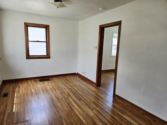 915 14th Ave SE, Austin, MN 55912 - empty room with healthy amount of natural light, dark wood finished floors, and a smoke detector