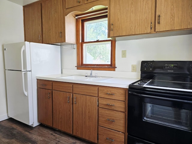 915 14th Ave SE, Austin, MN 55912 - kitchen with electric range, freestanding refrigerator, dark wood-style floors, light countertops, and brown cabinets