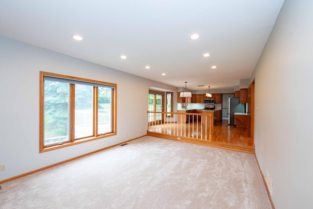 6262 Fernbrook Ln N, Maple Grove, MN 55311 - unfurnished living room featuring recessed lighting and light carpet