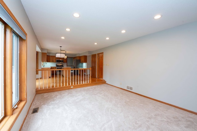 6262 Fernbrook Ln N, Maple Grove, MN 55311 - unfurnished living room featuring recessed lighting and light colored carpet