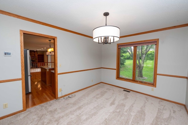 6262 Fernbrook Ln N, Maple Grove, MN 55311 - spare room with a chandelier, carpet, and ornamental molding