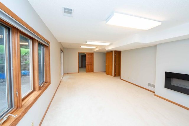 6262 Fernbrook Ln N, Maple Grove, MN 55311 - below grade area featuring light colored carpet and a glass covered fireplace