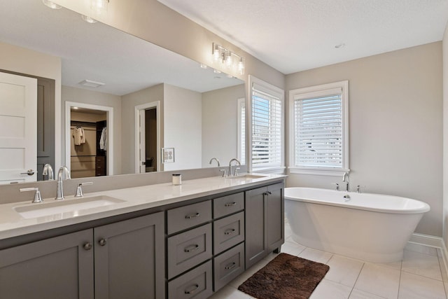 6333 Yuma Ln N, Maple Grove, MN 55311 - full bathroom featuring double vanity, a freestanding bath, tile patterned flooring, and a spacious closet