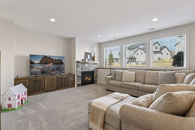 6333 Yuma Ln N, Maple Grove, MN 55311 - living room featuring carpet floors, a stone fireplace, recessed lighting, and a textured ceiling