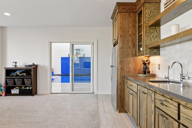 6333 Yuma Ln N, Maple Grove, MN 55311 - kitchen with freestanding refrigerator, brown cabinetry, decorative backsplash, dark countertops, and open shelves