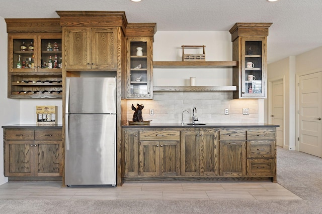 6333 Yuma Ln N, Maple Grove, MN 55311 - kitchen with freestanding refrigerator, open shelves, decorative backsplash, glass insert cabinets, and a textured ceiling