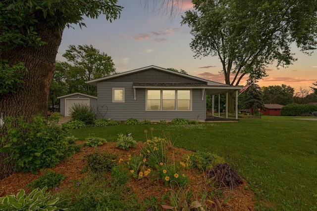 511 9th Ave SW, Faribault, MN 55021 - rear view of house featuring an outbuilding, a lawn, and a garage
