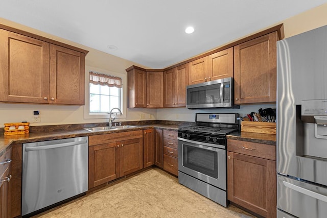 511 9th Ave SW, Faribault, MN 55021 - kitchen with stainless steel appliances, dark countertops, brown cabinetry, and recessed lighting