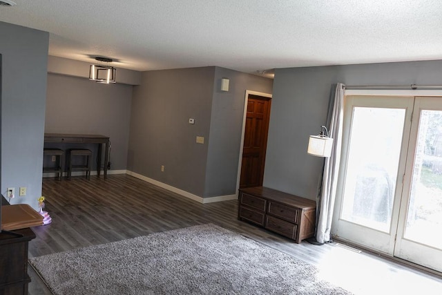 508 Jackson St SW, Hutchinson, MN 55350 - unfurnished living room with plenty of natural light, wood finished floors, and a textured ceiling