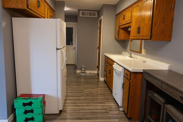 508 Jackson St SW, Hutchinson, MN 55350 - kitchen with white appliances, brown cabinets, light countertops, and dark wood-style floors