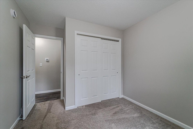 3667 205th St W, Farmington, MN 55024 - unfurnished bedroom with carpet, a closet, and a textured ceiling