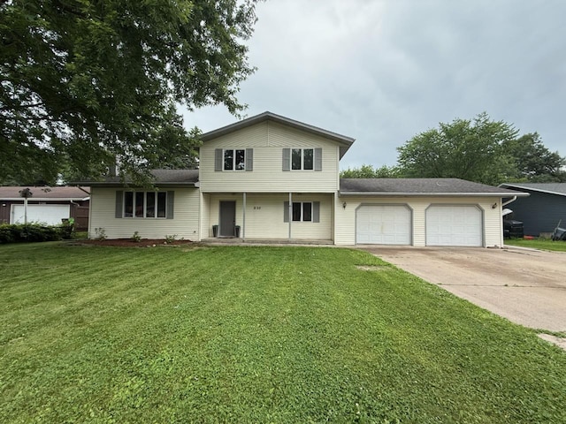 2152 Orchard Pl, Eau Claire, WI 54703 - tri-level home with an attached garage, driveway, a front yard, and covered porch