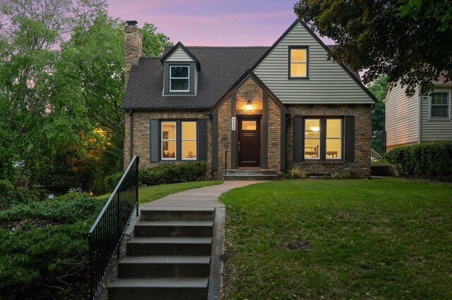 4236 22nd Ave S, Minneapolis, MN 55407 - view of front of property featuring a chimney, brick siding, a front lawn, and a shingled roof