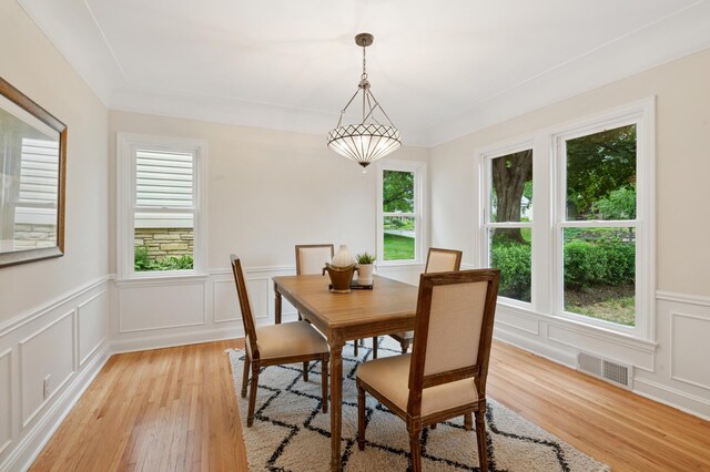 4236 22nd Ave S, Minneapolis, MN 55407 - dining room featuring plenty of natural light, light wood-style flooring, a decorative wall, and wainscoting