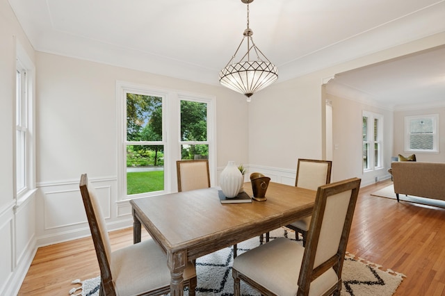 4236 22nd Ave S, Minneapolis, MN 55407 - dining area with light wood-type flooring, a decorative wall, and a wainscoted wall