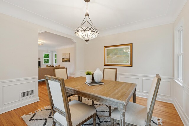 4236 22nd Ave S, Minneapolis, MN 55407 - dining area featuring a decorative wall, wainscoting, and light wood-style flooring