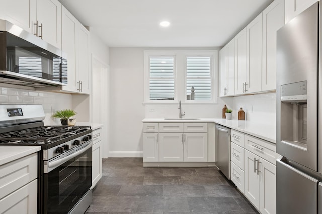 4236 22nd Ave S, Minneapolis, MN 55407 - kitchen featuring appliances with stainless steel finishes, backsplash, light countertops, white cabinetry, and recessed lighting