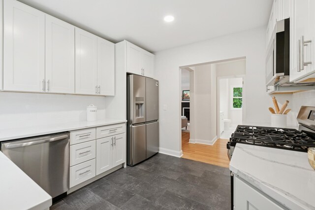 4236 22nd Ave S, Minneapolis, MN 55407 - kitchen with stainless steel appliances, white cabinets, recessed lighting, and light stone countertops