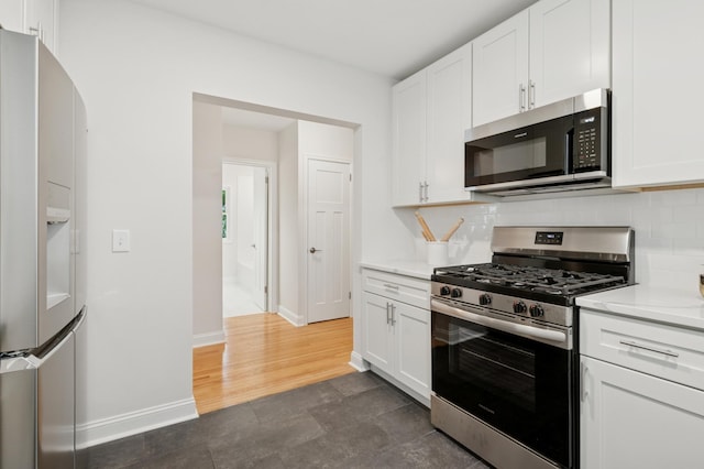 4236 22nd Ave S, Minneapolis, MN 55407 - kitchen with stainless steel appliances, white cabinetry, tasteful backsplash, and arched walkways
