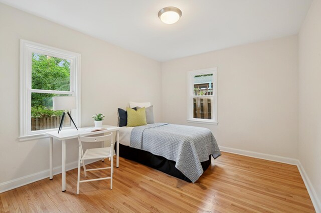 4236 22nd Ave S, Minneapolis, MN 55407 - bedroom featuring multiple windows and light wood-style flooring